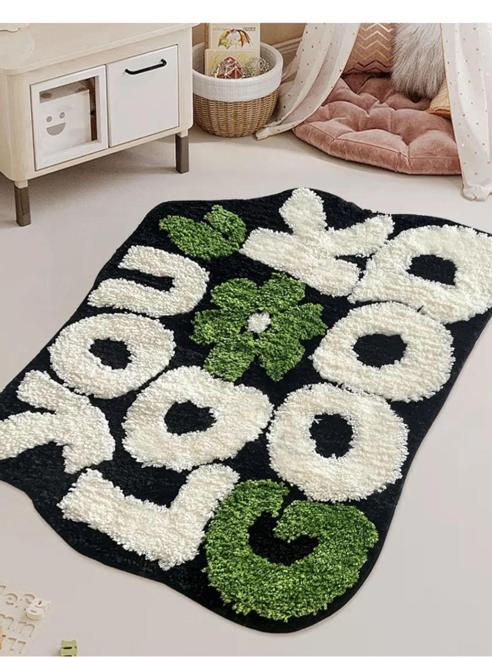 Black Fuzzy Rug with Cream Letters and Green Floral Accents